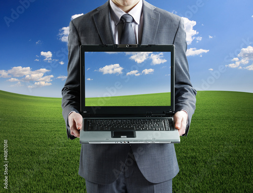 Photo: Businessman holding his laptop Businessman holding his laptop