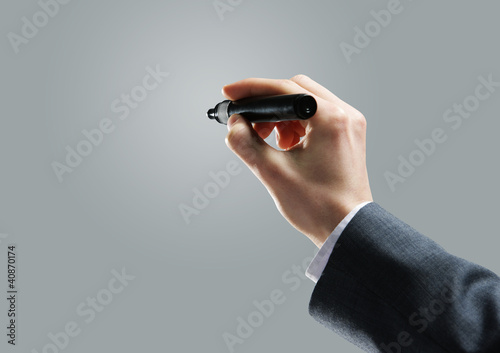 Photo: Businessman hand drawing in a blank whiteboard Businessman hand drawing in a blank whiteboard