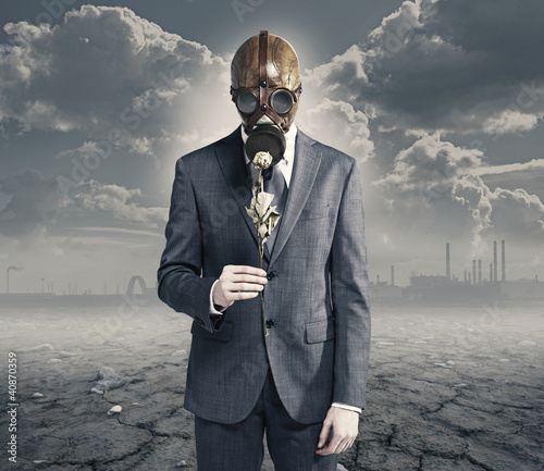 Photo: businessman with dried rose: concept polluted environment businessman with dried rose: concept polluted environment