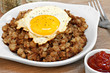 Fried egg on top of roast beef hash.