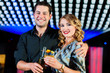 People with cocktails in bar or club