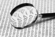 magnifying glass on a binary code