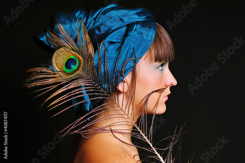 Photo: Young woman in blue turban with peacock feather Young woman in blue turban with peacock feather