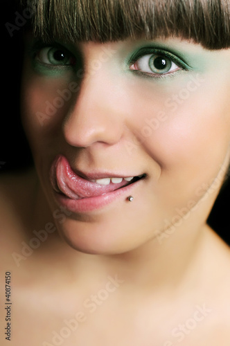 Photo: Funny expressive teen girl sticking out tongue Funny expressive teen girl sticking out tongue