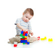 cheerful child boy playing with construction set