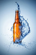 Beer bottle with water splash