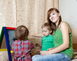Woman and children draws on  blackboard
