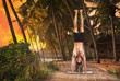 Yoga handstand pose at sunset