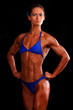 Photo en ligne au meilleur prix muscular woman posing against black background.