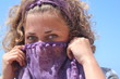 Young woman covering her face