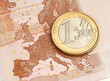 One Euro Coin on Euro Banknote showing Map of Europe