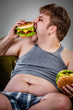 fat man eating hamburger