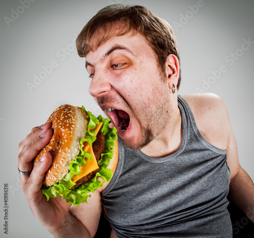 fat man eating hamburger