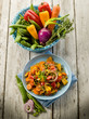 mixed sauteed vegetables on dish over wood background mixed sauteed vegetables on dish over wood background