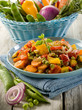 mixed sauteed vegetables on dish over wood background mixed sauteed vegetables on dish over wood background