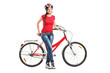Smiling female posing next to a bicycle
