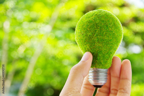 Photo: hand holding eco light bulb energy concept hand holding eco light bulb energy concept