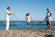 Summer vacation - family playing at the beach Summer vacation - family playing at the beach