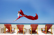 Carefree woman jumping at beach