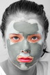 Photo: Sad teenager with grey cosmetic mask Sad teenager with grey cosmetic mask