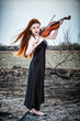 The red-haired girl with a violin outdoor
