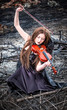 The red-haired girl with a violin sitting on the ashes
