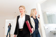 Young couple looking for real estate with female realtor