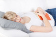 frau mit buch auf dem sofa