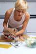 pretty blond girl in the kitchen making pasta