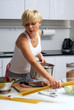 pretty blond girl in the kitchen making pasta