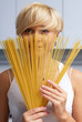 pretty blond girl in the kitchen making pasta