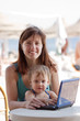 happy mother and toddler with laptop at resort happy mother and toddler with laptop at resort