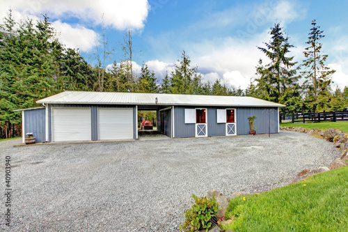 Photo: Horse farm stable buidling with horses and garage. Horse farm stable buidling with horses and garage.