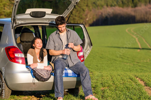 Photo: Camping couple inside car summer sunset countryside Camping couple inside car summer sunset countryside