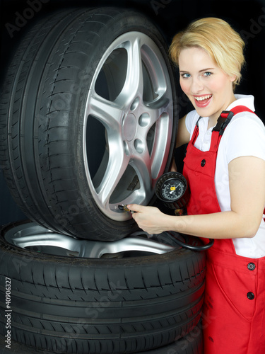 Photo: Apprentice learns to check air pressure of a summer tire Apprentice learns to check air pressure of a summer tire