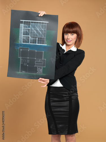 Photo: attractive, young architect showing blueprint of house attractive, young architect showing blueprint of house
