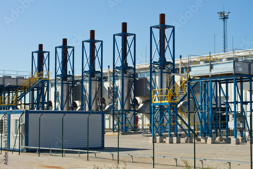 Photo: petrochemical refinery pipes and tanks in a factory petrochemical refinery pipes and tanks in a factory