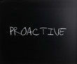 'Proactive' handwritten with white chalk on a blackboard
