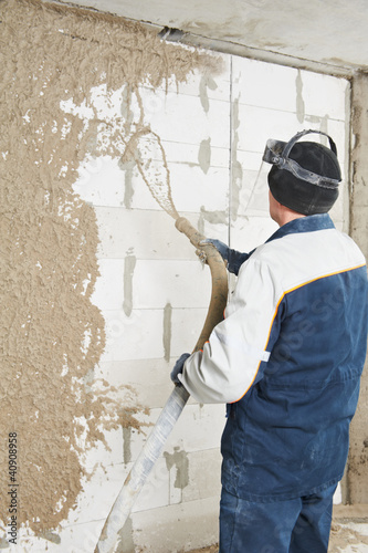 Photo: Plasterer at stucco work with liquid plaster Plasterer at stucco work with liquid plaster
