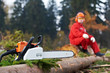 Lumberjack Worker With Chainsaw In The Forest