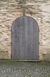 vintage gray wooden door with brick wall