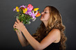 Photo: Young, beautiful woman with a colorful bouquet of flowers Young, beautiful woman with a colorful bouquet of flowers