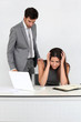 Businessman in office harassing young woman