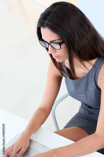 Photo: Beautiful woman working on laptop computer Beautiful woman working on laptop computer