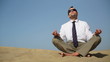 Businessman sitting on the beach and meditating