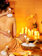 Woman getting thai herbal massage ball. Woman getting thai herbal massage ball.