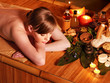 Woman getting massage in bamboo spa.