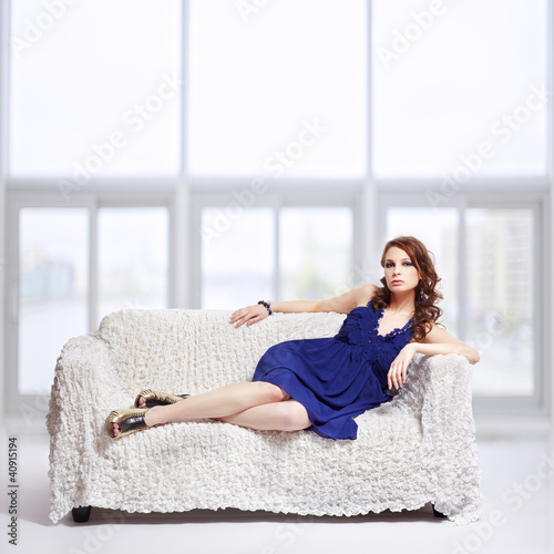 Photo: brunette relaxing on sofa brunette relaxing on sofa