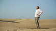 Lonely man standing in the desert