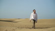 Young man looking around at the desert